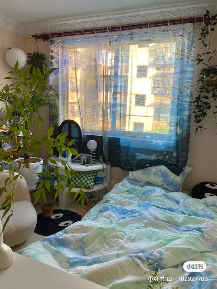 a bed room with a neatly made bed next to a window and potted plants