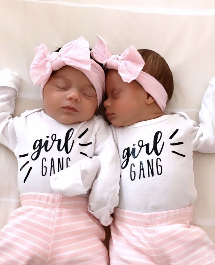 two baby girls sleeping next to each other