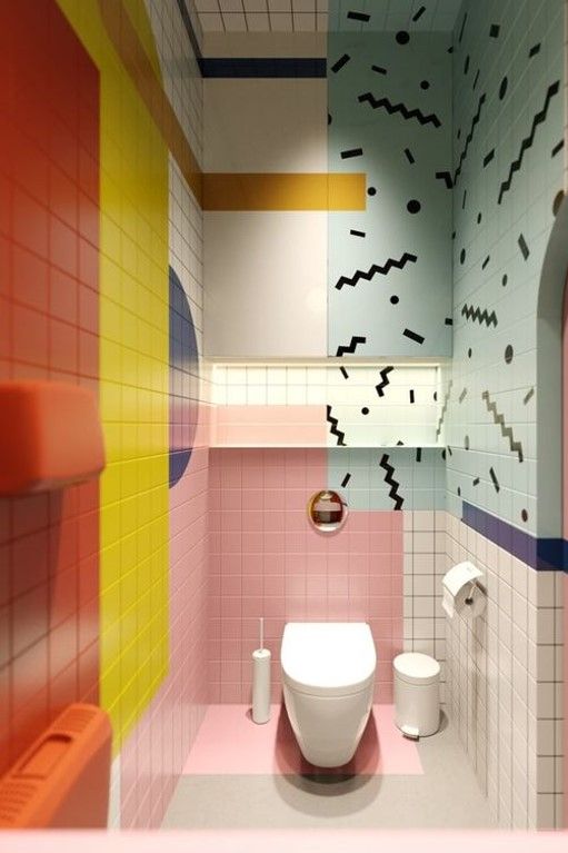 a bathroom with pink, yellow, and blue tiles on the walls next to a toilet