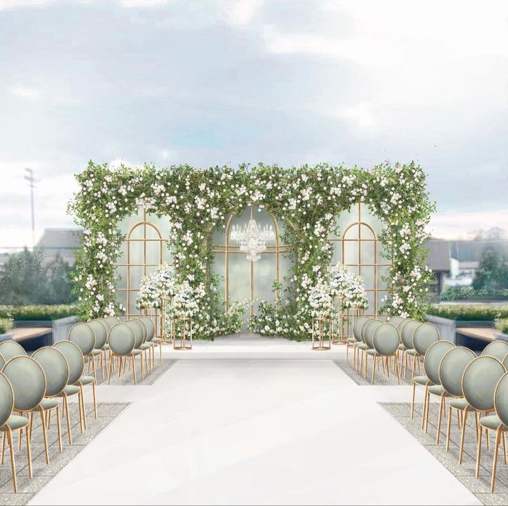 an outdoor ceremony setup with chairs, flowers and greenery on either side of the aisle