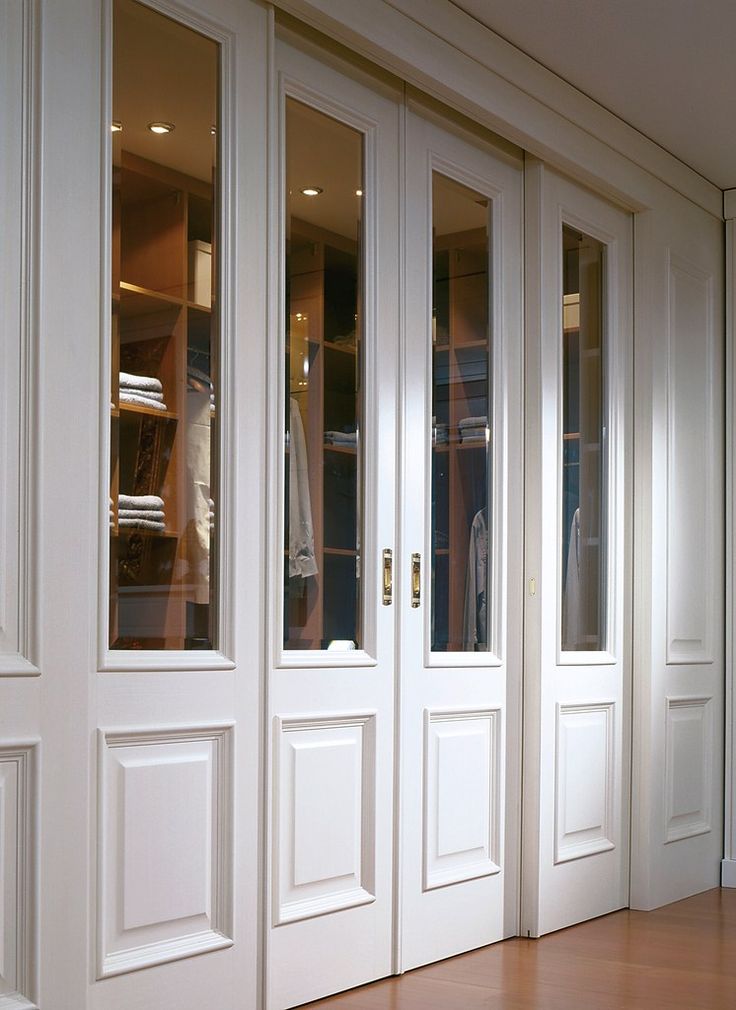 an empty room with wooden floors and white doors