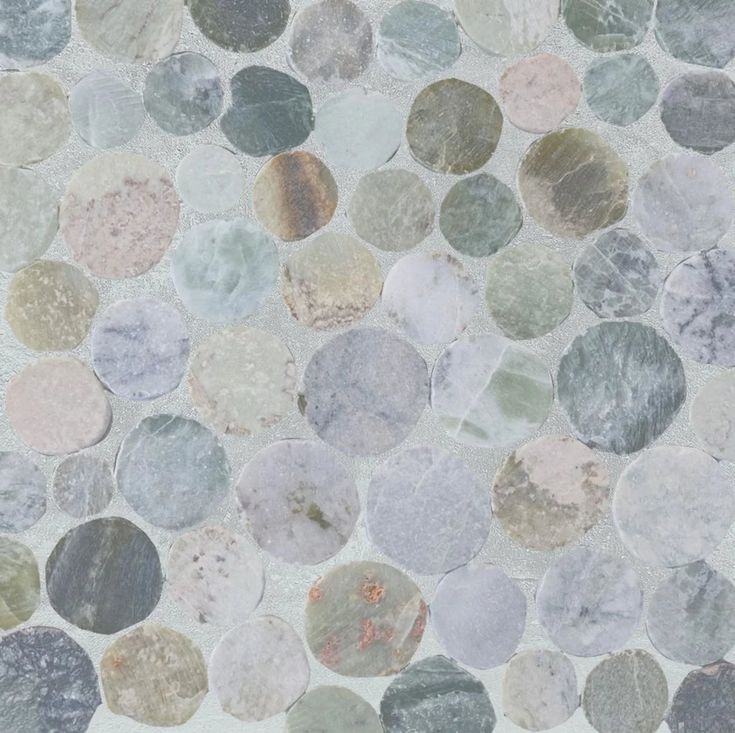 a close up view of a tile floor with different colors and sizes of stones on it