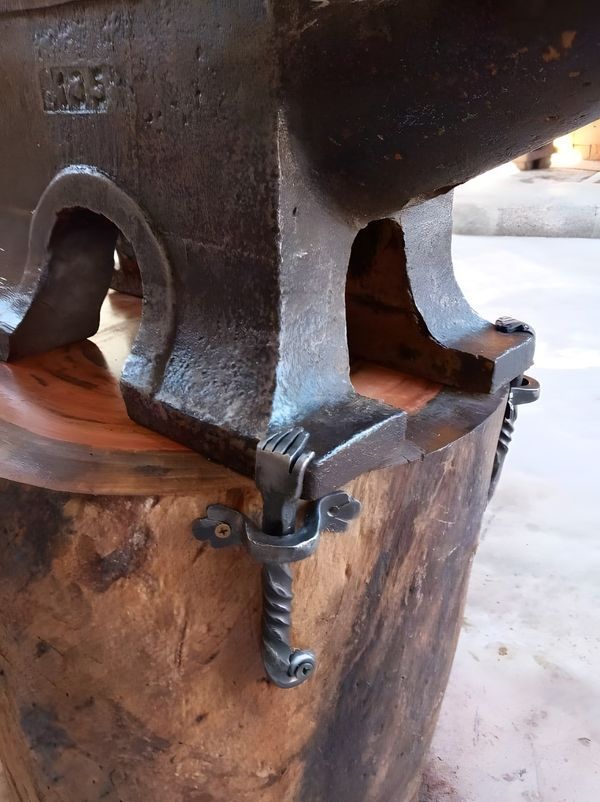 an old metal object sitting on top of a wooden barrel