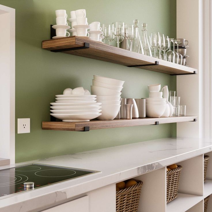 two open shelves filled with dishes and glasses on top of a white kitchen countertop