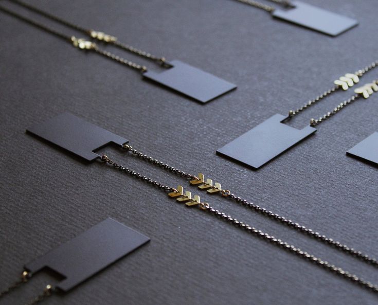 This matte black geometric long necklace is enhanced by cute brass chevron details! :) * Rectangular pendant, matte black plated by hand * Brass chevron chain * Small faceted black plated brass chain * No clasp, just slip it on! Necklace about 37in (94cm) all around. Pendant size 1.5in (39mm) high, and just over 0.75in (2cm) wide. ----- * Pendentif rectangulaire, plaqué à la main couleur noir mat * Chaîne en chevrons en laiton * Petite chaîne de laiton, plaquée noire, à facettes * Pas d'attache, Black Long Necklace, Extra Long Necklace, Black Gold Chain, Chevron Necklace, Rectangle Pendant, Long Necklaces, Bee Necklace, Mismatched Earrings, Gold Necklace Women