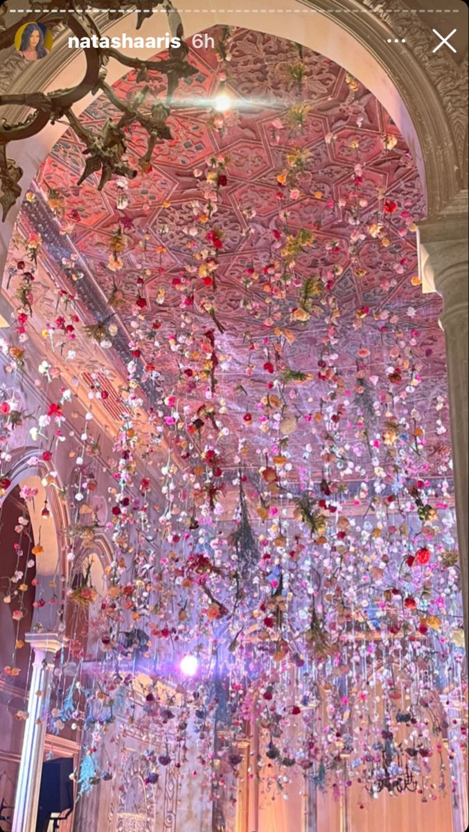 a large chandelier hanging from the ceiling in a room filled with lots of glass beads