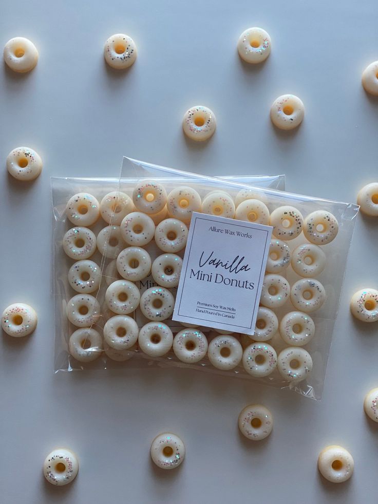 bag of mini donuts on white surface surrounded by small doughnuts