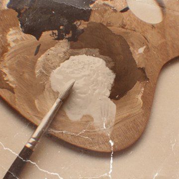 a wooden spoon with some white powder on it and a paintbrush next to it