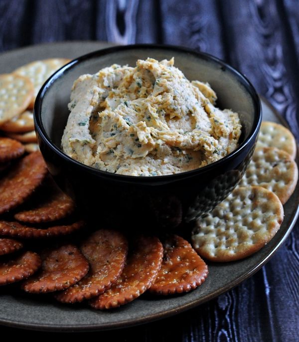 a plate with crackers and dip on it