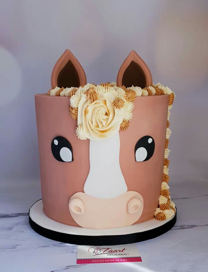 a cake decorated with a horse's head and flowers