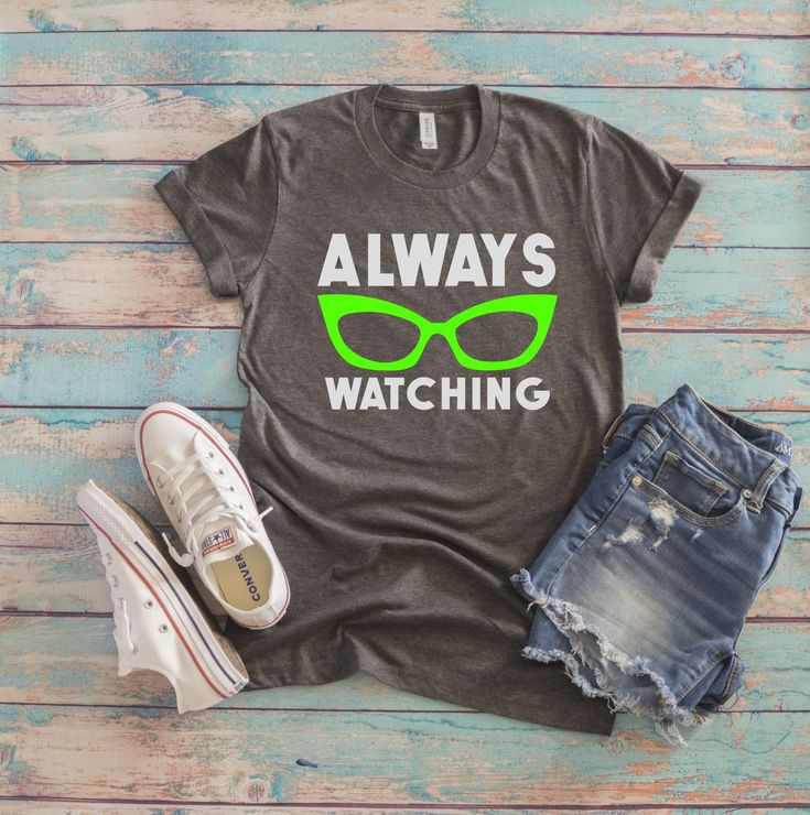 a t - shirt that says, always watching with green glasses on it and ripped shorts