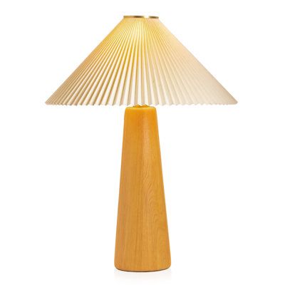 a wooden table lamp with a white shade