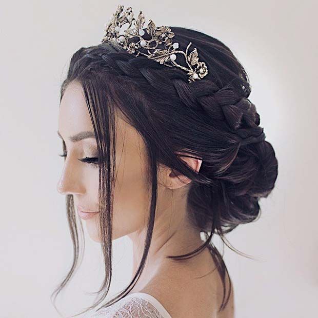 a woman wearing a tiara with flowers in her hair