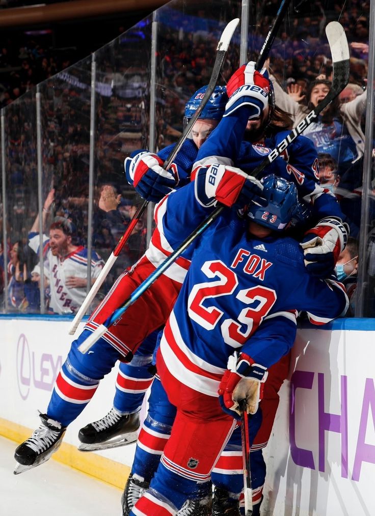 the hockey players are hugging each other on the ice