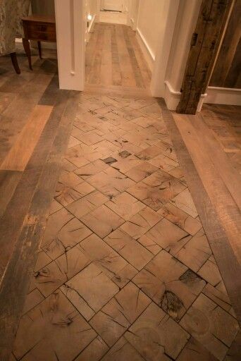 an empty hallway with wood flooring and white walls