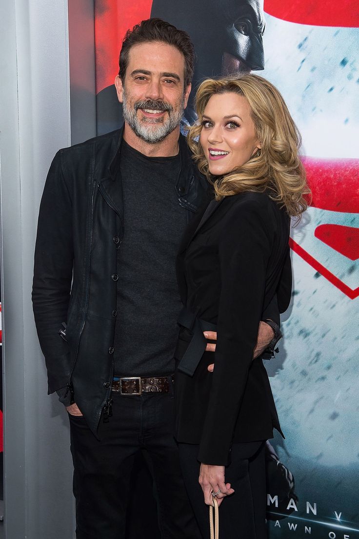 a man and woman standing next to each other on the red carpet at an event