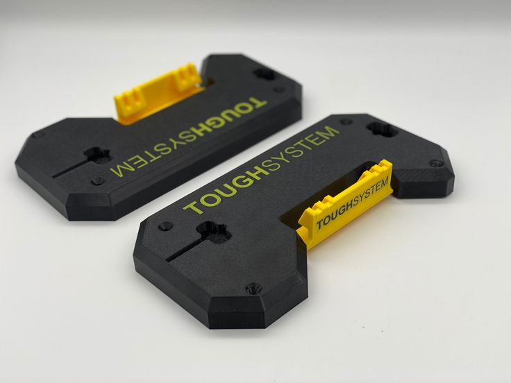 two black and yellow tape dispensers on a white surface