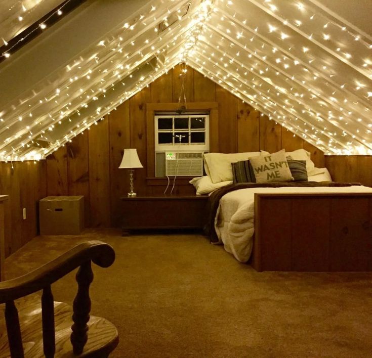 an attic bedroom decorated with fairy lights