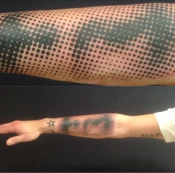 the arm is covered in black dots and has an american flag on it, while another shows