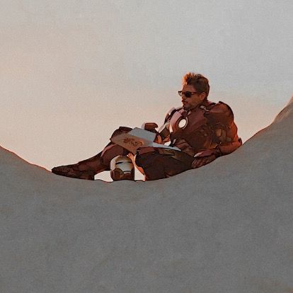 a man sitting on top of a snow covered slope