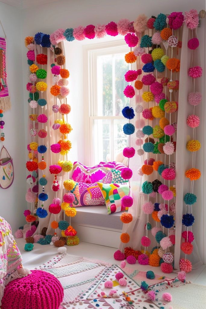 colorful pom - poms are hanging from the window sill in this bedroom