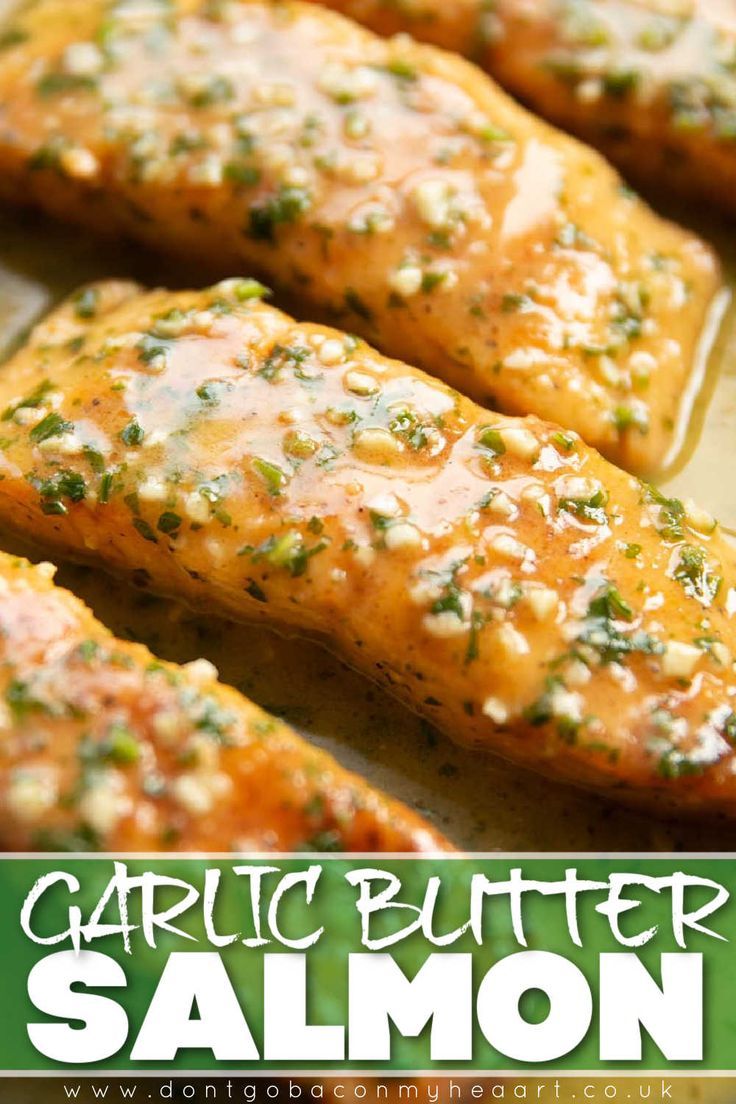 garlic butter salmon fillets on a baking sheet with the title text above it that reads garlic butter salmon