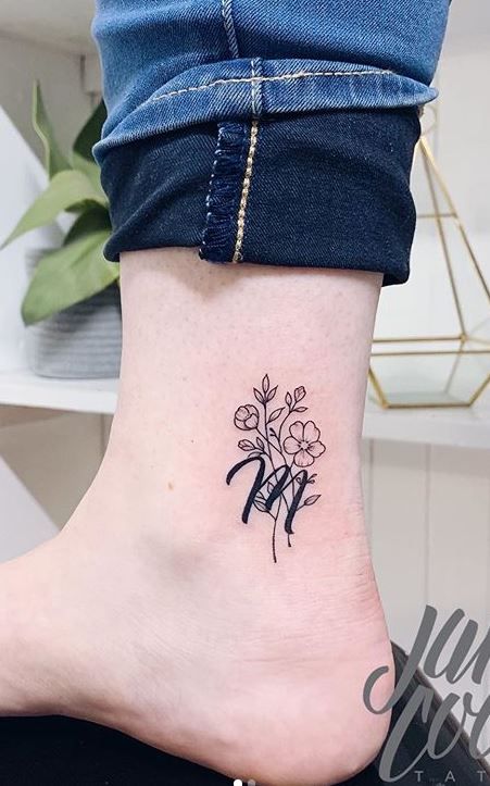 a woman's foot with a small flower tattoo on her left side ribcage