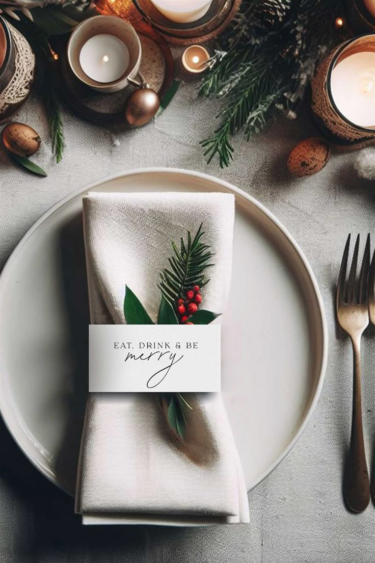 a place setting with silverware, candles and napkins that say eat often be merry