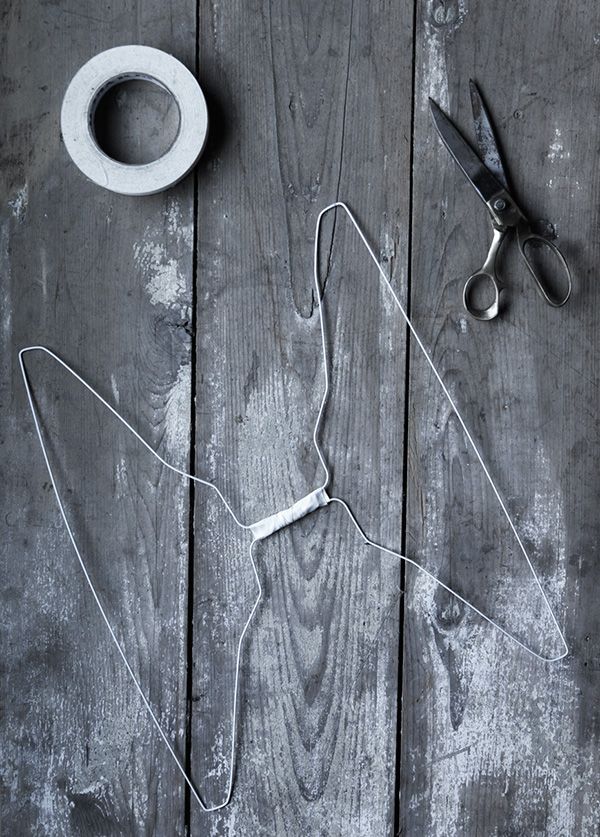 a pair of scissors and some tape on a wooden table