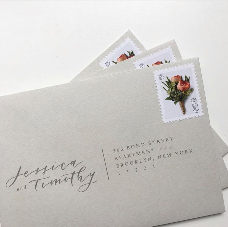 three envelopes with stamps on them are sitting next to each other