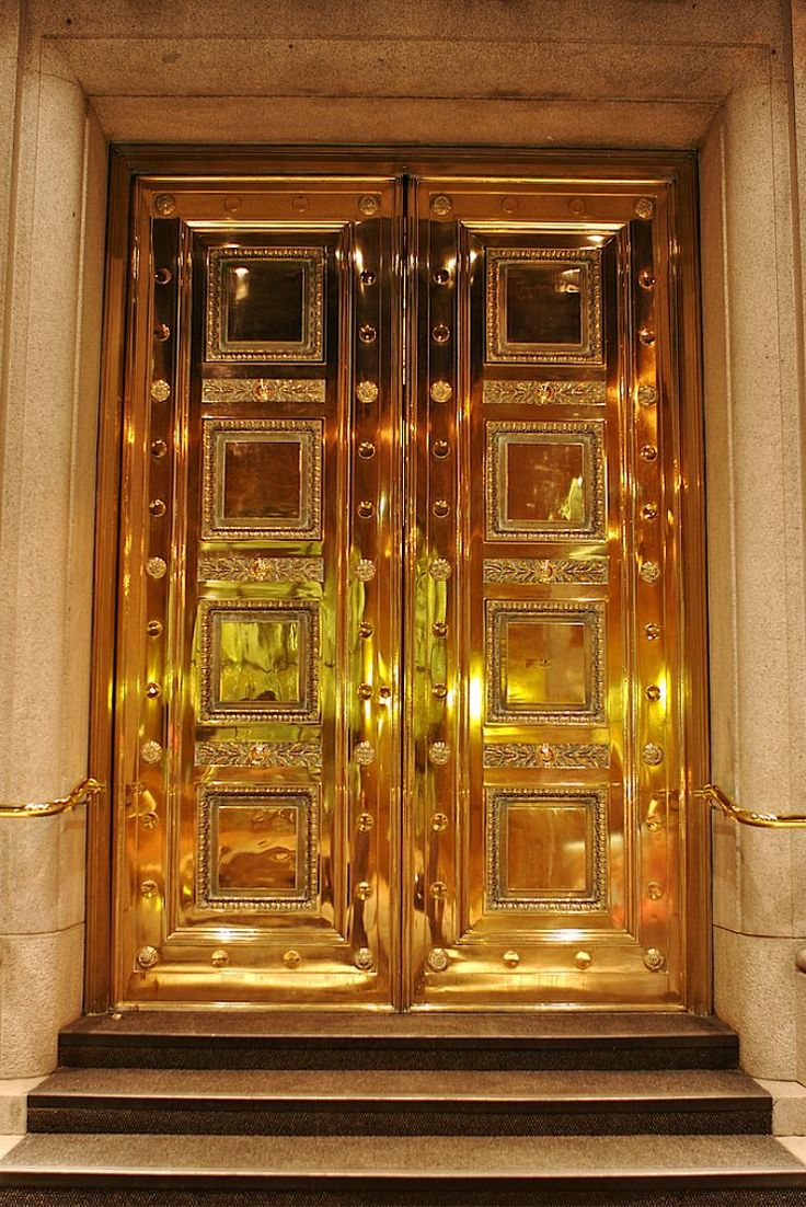 an ornate gold door with steps leading up to it