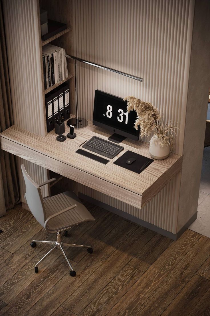 a desk with a laptop computer on top of it and a plant next to it