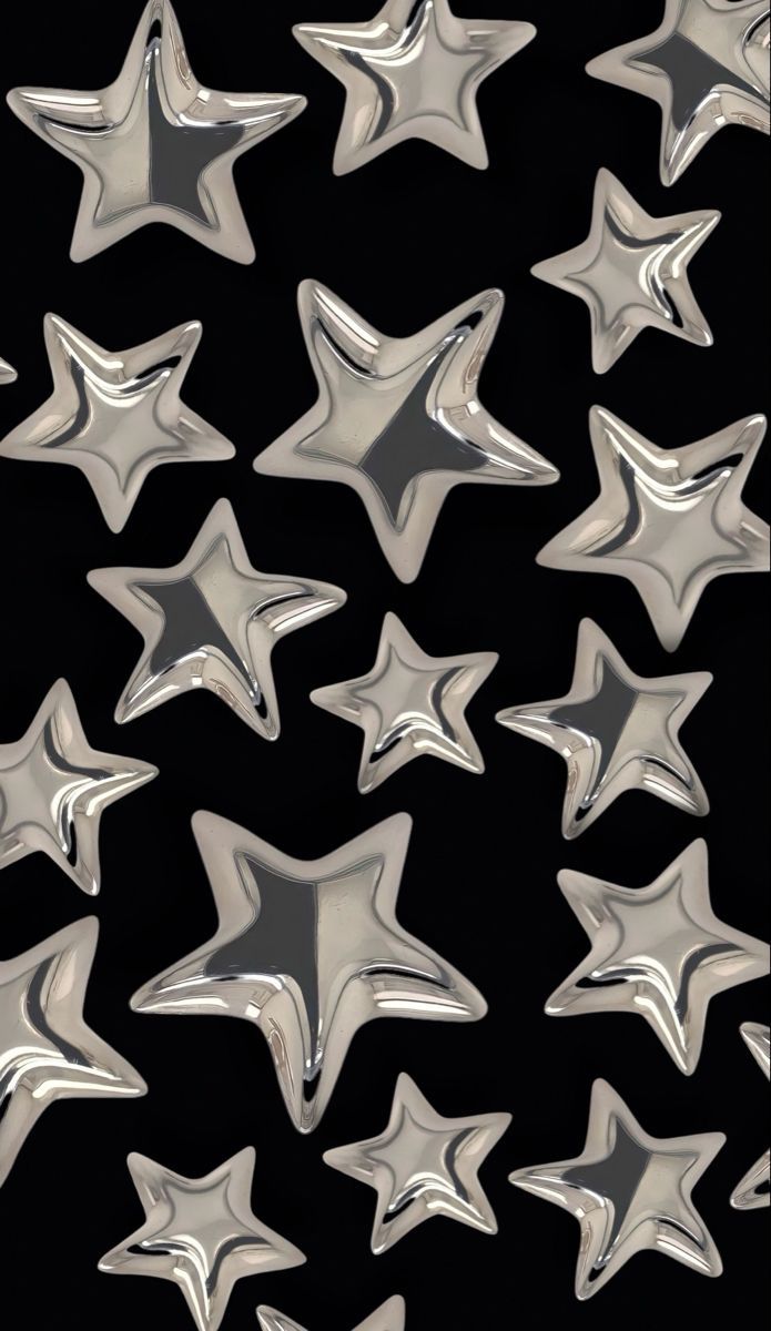 many shiny silver stars on a black background