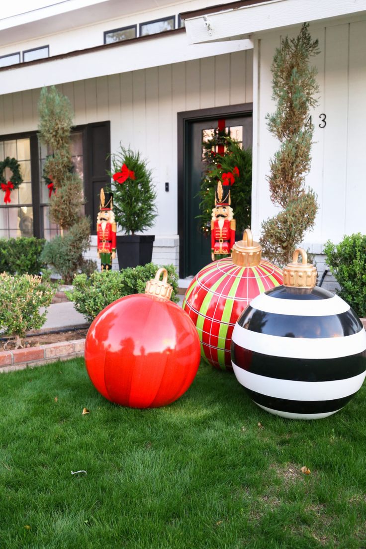 christmas decorations on the lawn in front of a house