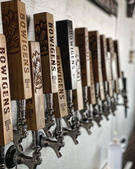 a row of beer taps mounted to the side of a wall