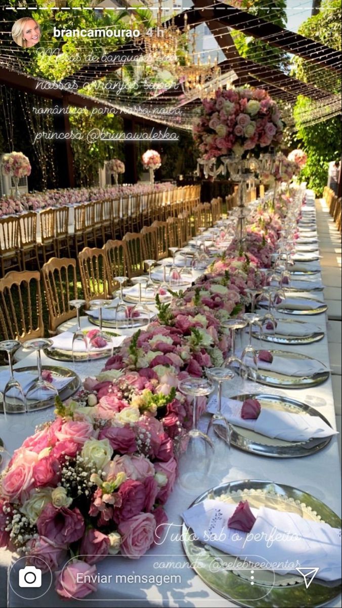 a long table with plates and flowers on it