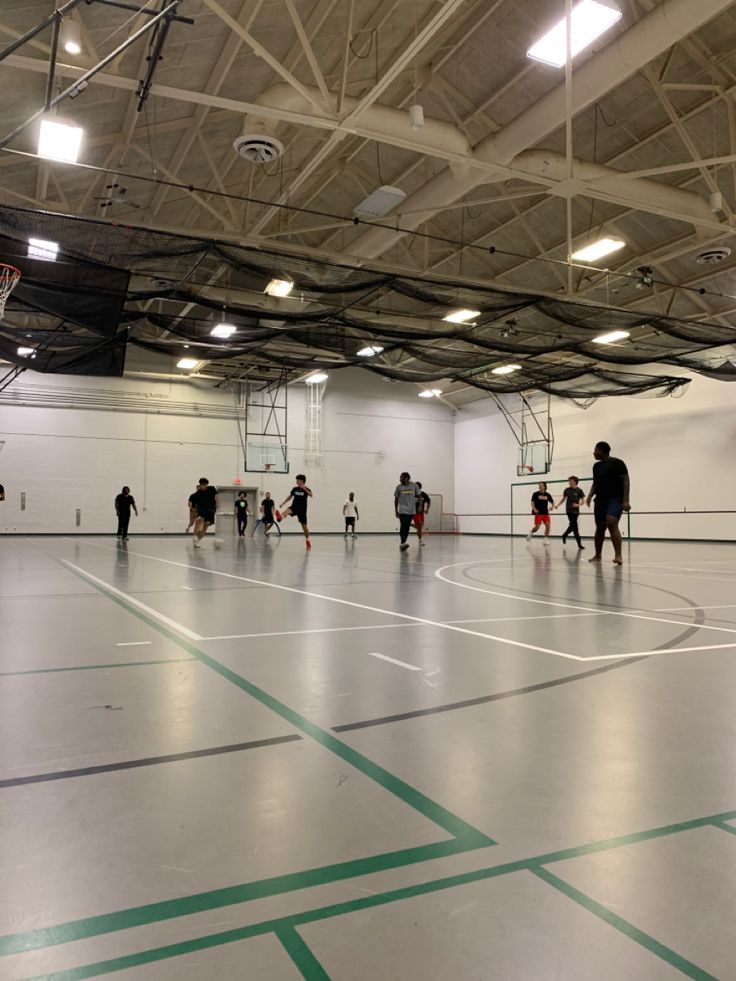 an indoor basketball court with people on it