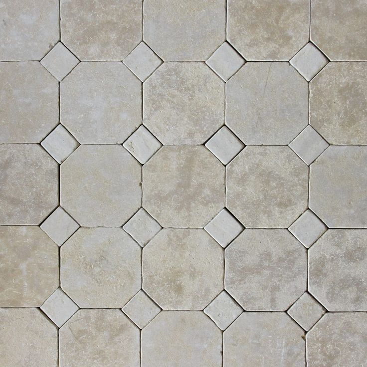 a tile floor with hexagonal shapes in grey and white