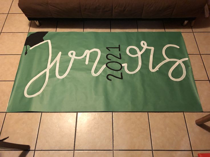 a large green banner with the name jerry on it in front of a brown couch