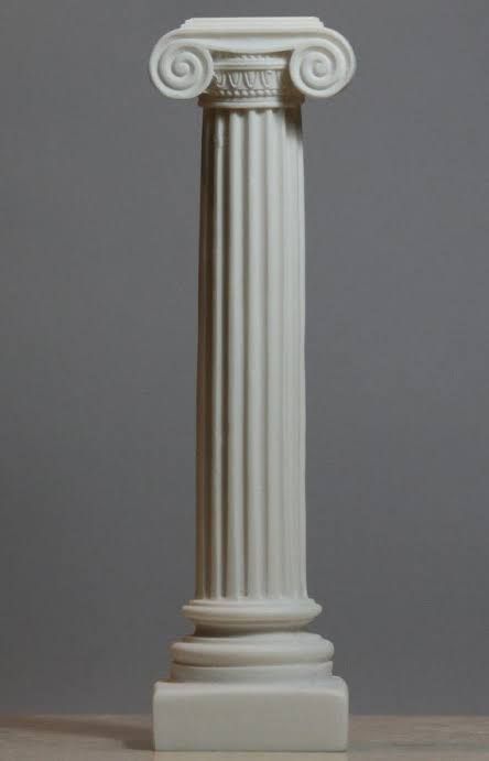 a tall white column on a wooden table