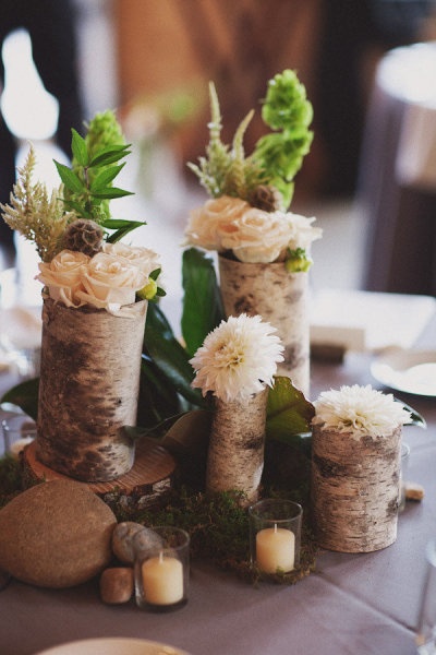 the centerpieces are made out of birch logs and flowers