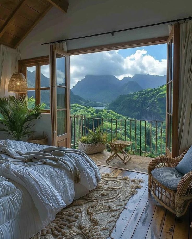 a bedroom with a large window overlooking the mountains