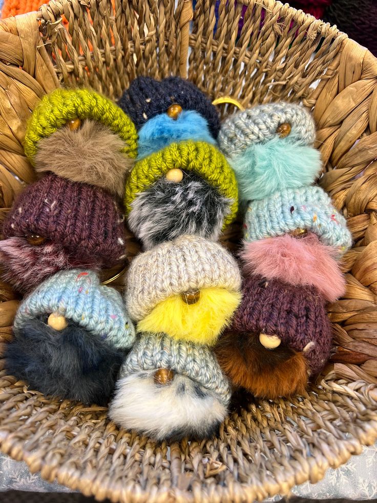 a basket filled with lots of knitted hats