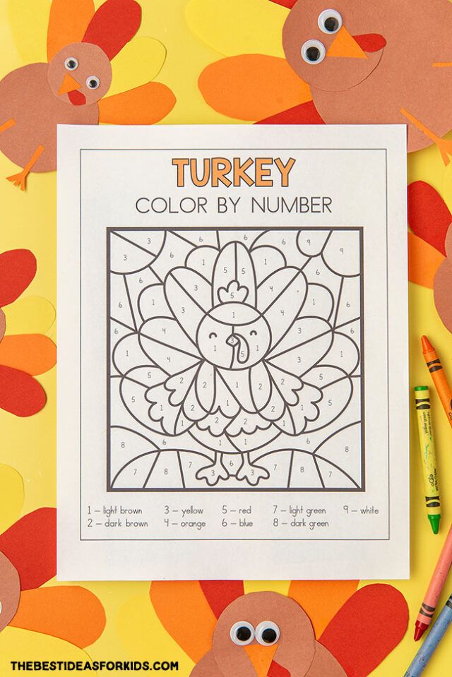 a turkey color by number page with crayon markers and pencils on the table