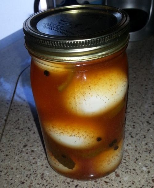 a jar filled with liquid sitting on top of a counter