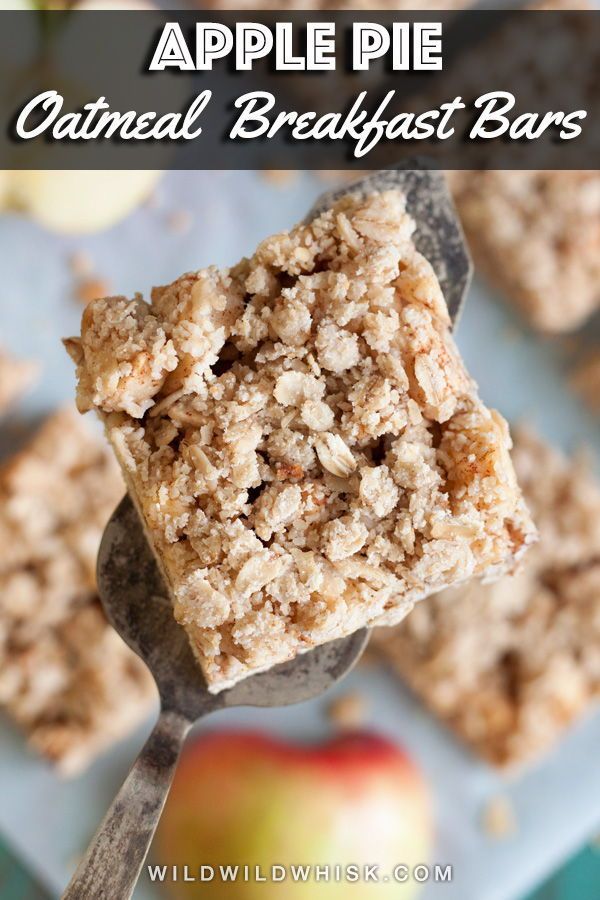 an apple and oatmeal dessert on a spoon with apples in the background