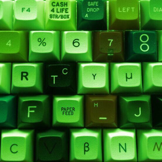 a computer keyboard with green keys and numbers on it's backgrounge