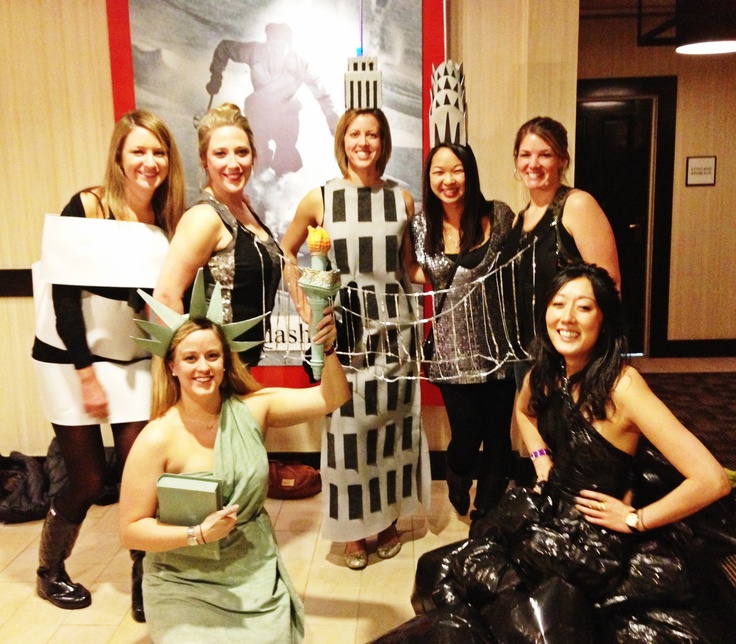 a group of women dressed in costumes posing for a photo