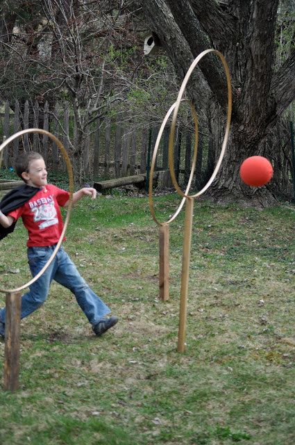 a young boy is playing with hoop tossers