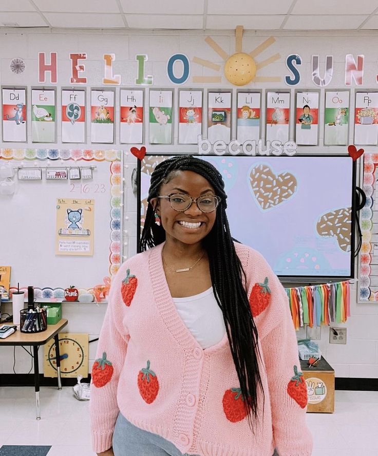 a woman standing in front of a classroom with lots of magnets on the wall